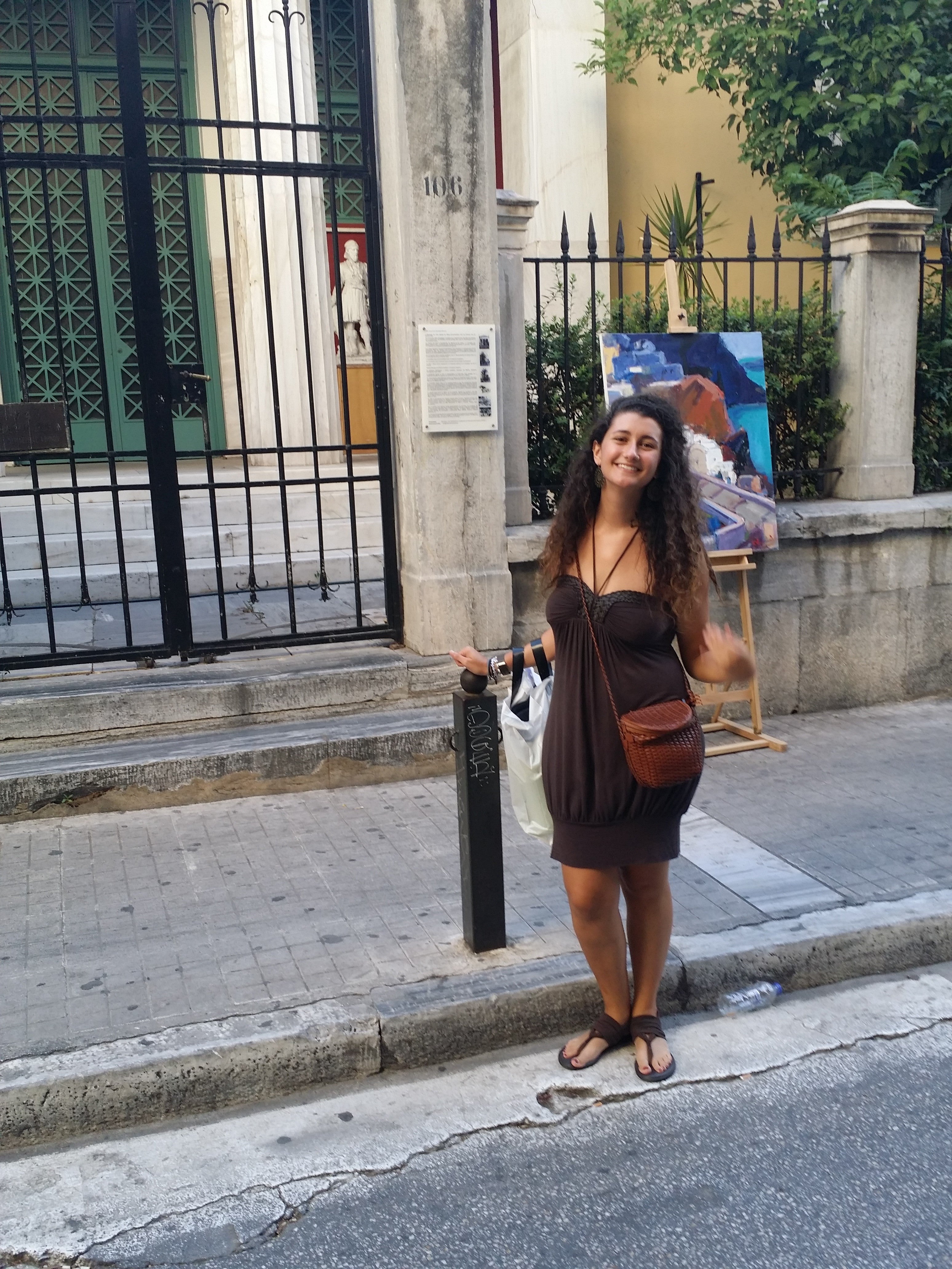 woman standing next to street sign