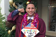 man posing in cap and gown