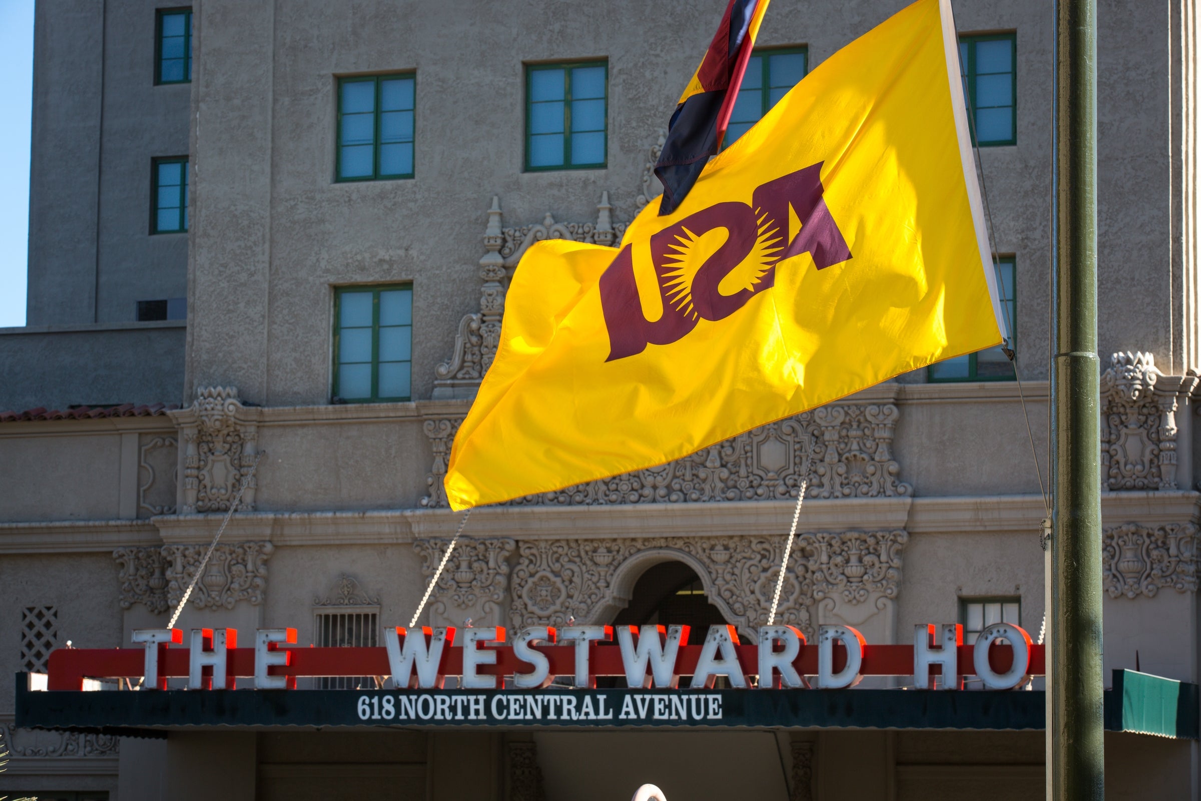 An ASU flag flies across the street from the Westward Ho