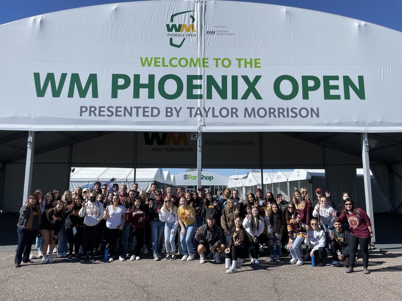 ASU events management students pose for a group photo at the TPC Scottsdale, site of the 2022 Waste Management Phoenix Open.