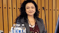 Woman smiling behind lectern