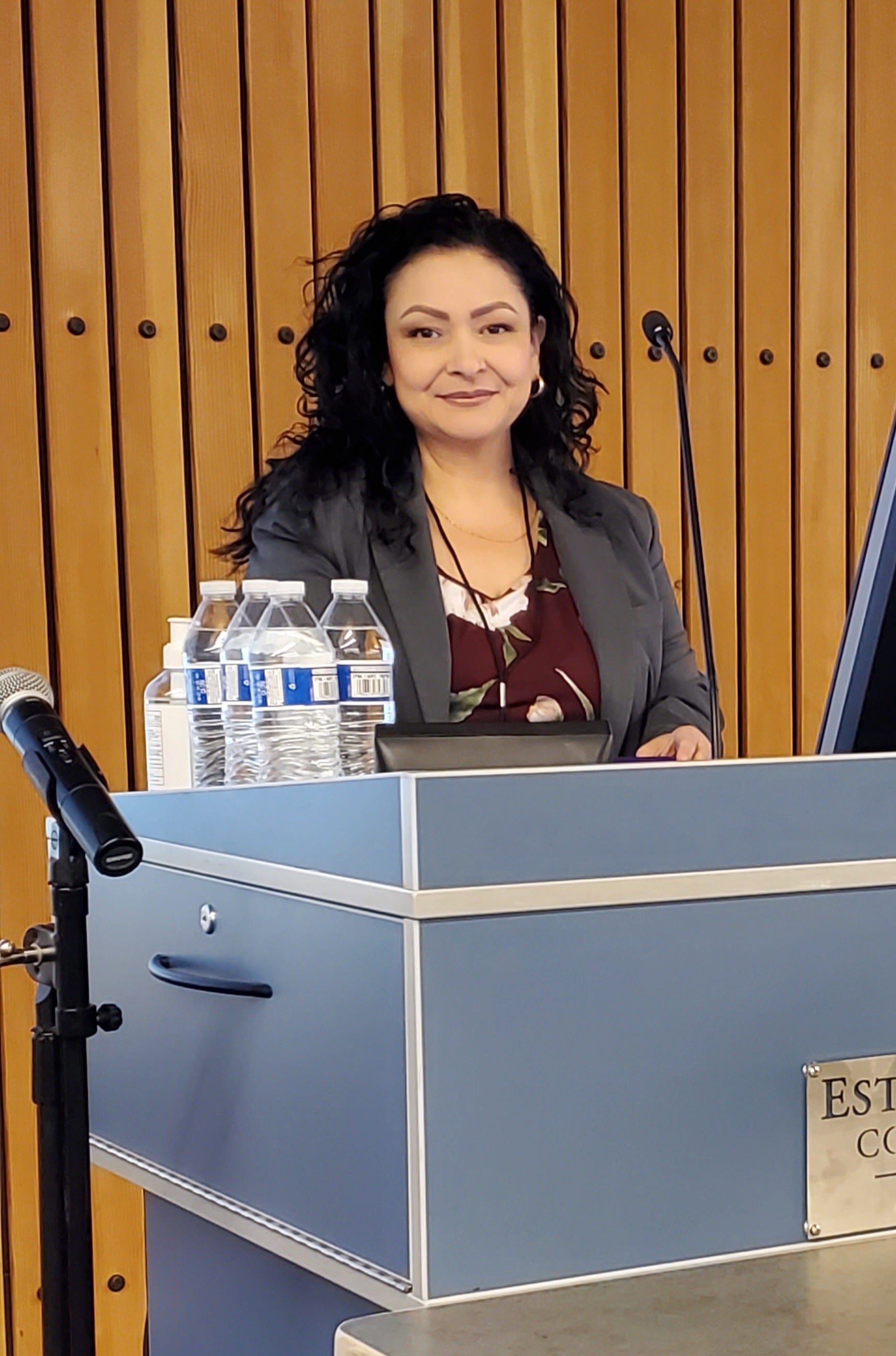 Woman standing behind lectern